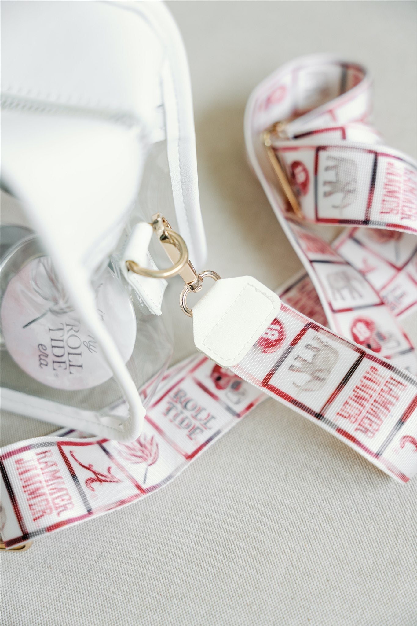 Clear bag with University of Alabama themed strap.