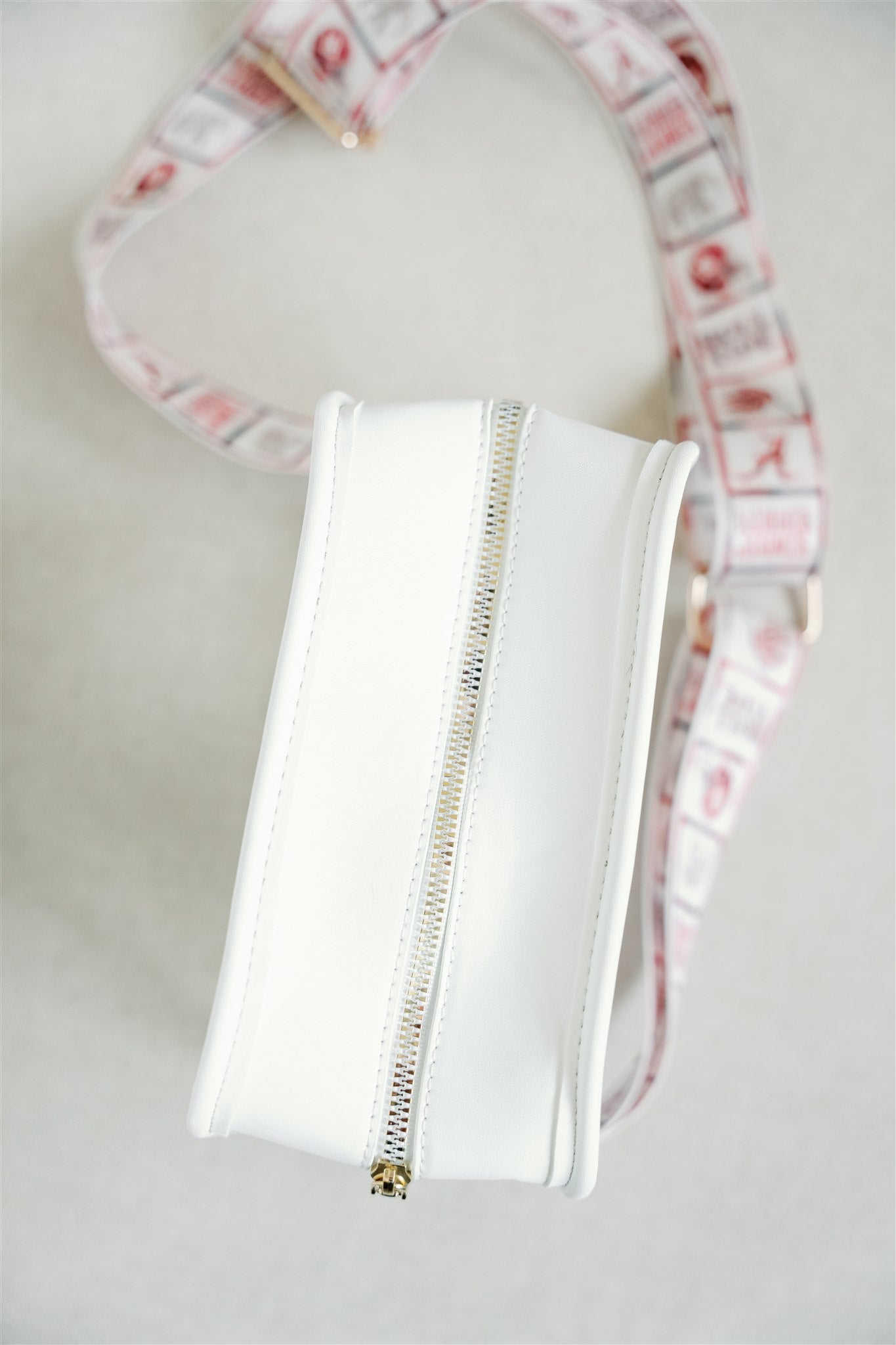 Clear bag with University of Alabama themed strap.