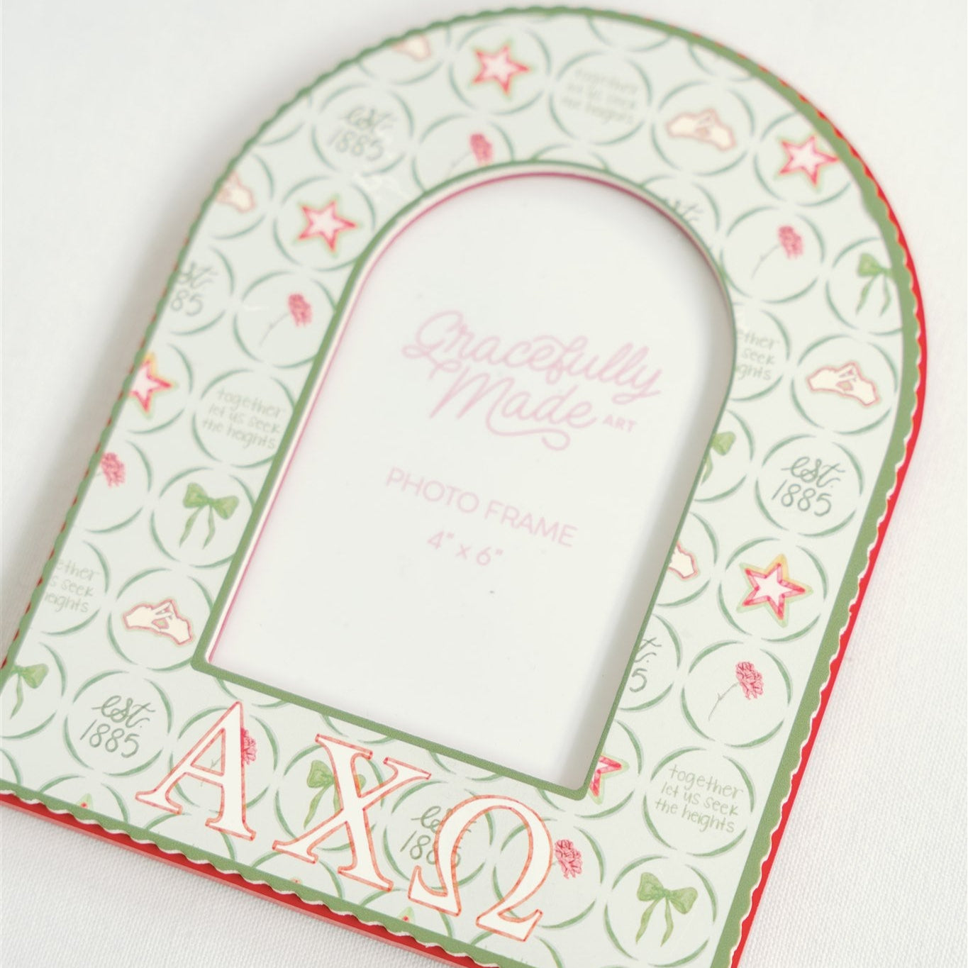 Decorative photo frame with Alpha Chi Omega design on a white background