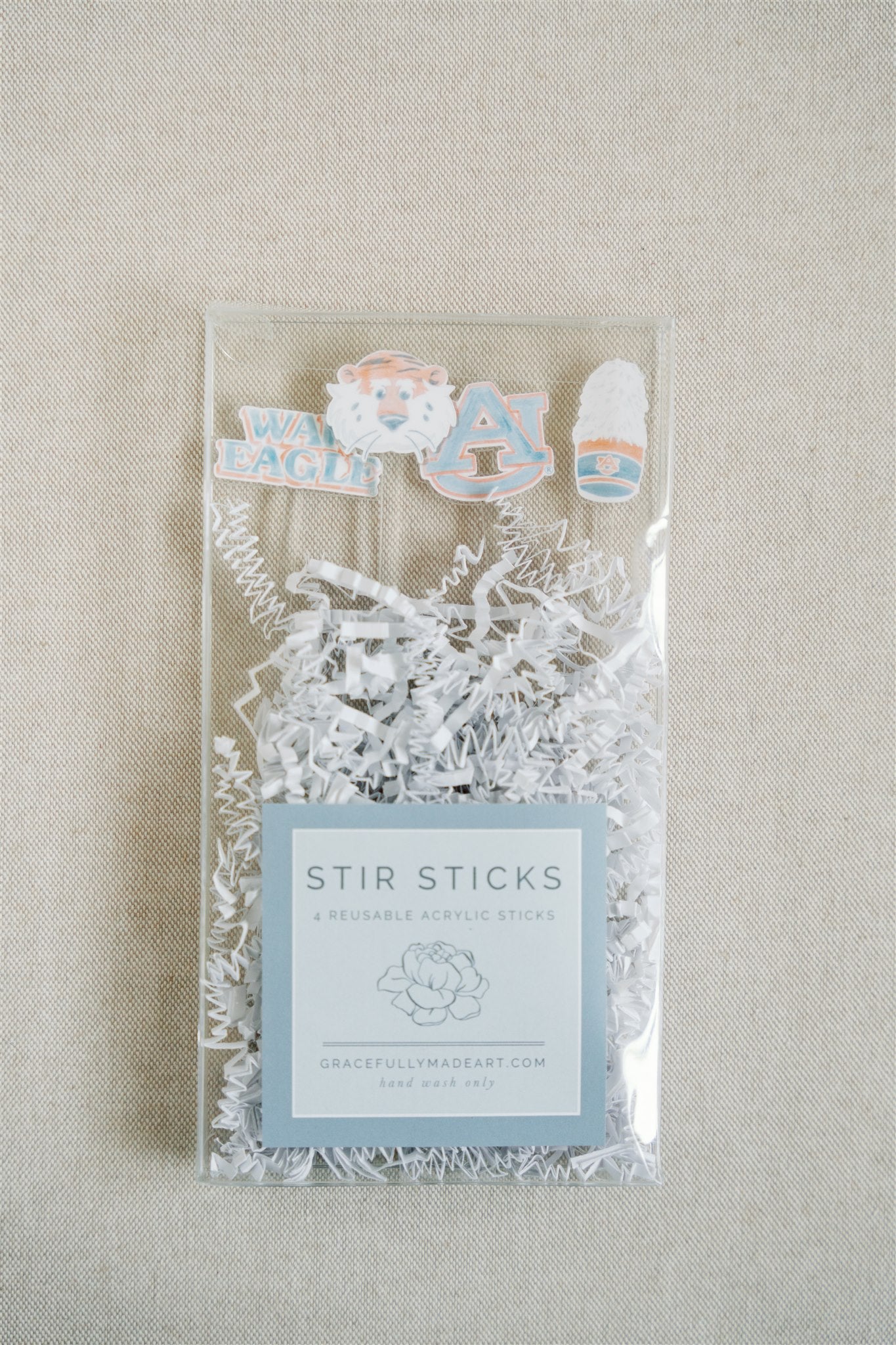 Acrylic stir sticks with watercolor Auburn University icons on the top of them.