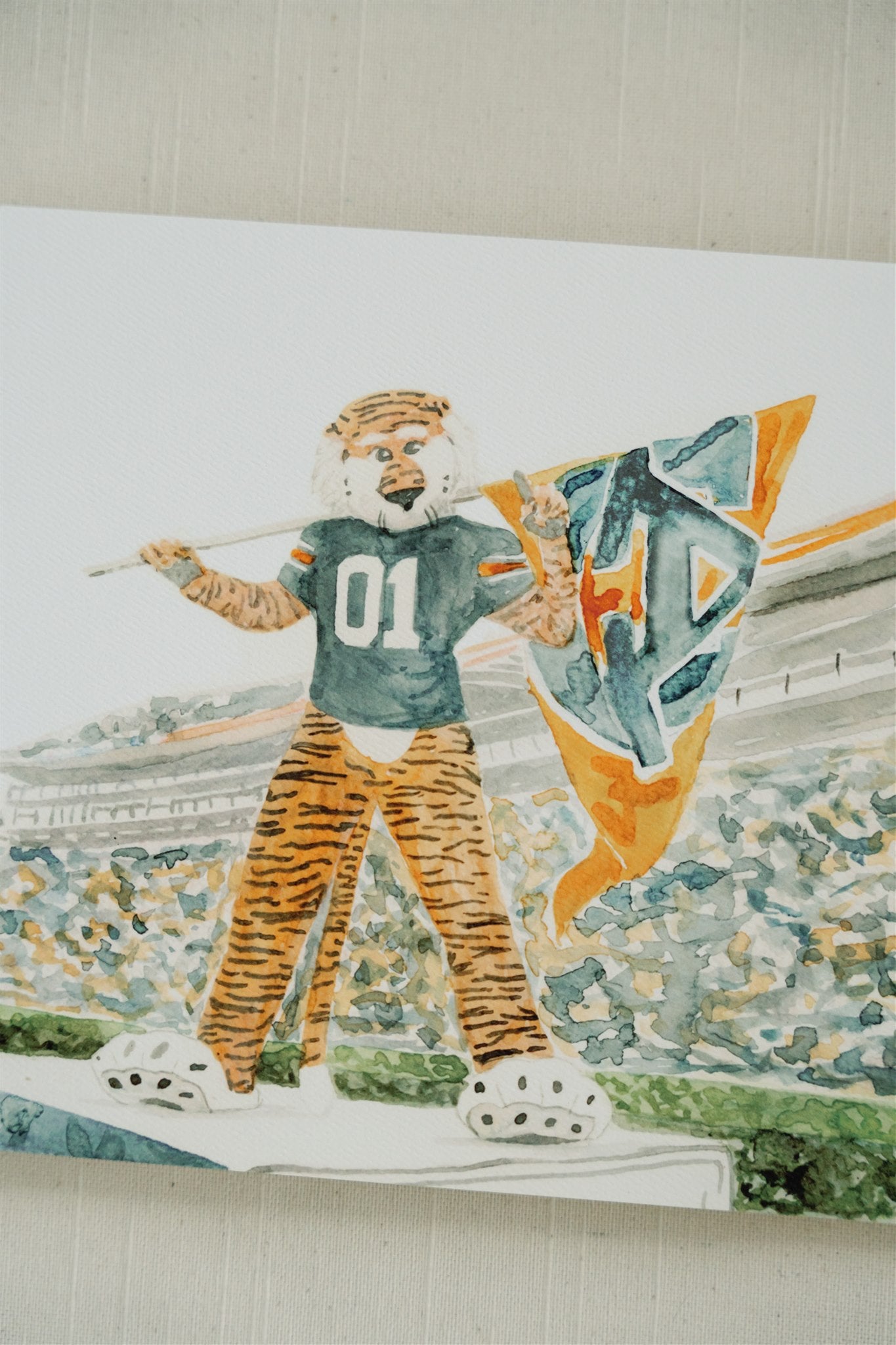 Watercolor art of Auburn University's mascot, Aubie, in Jordan Hare Stadium.