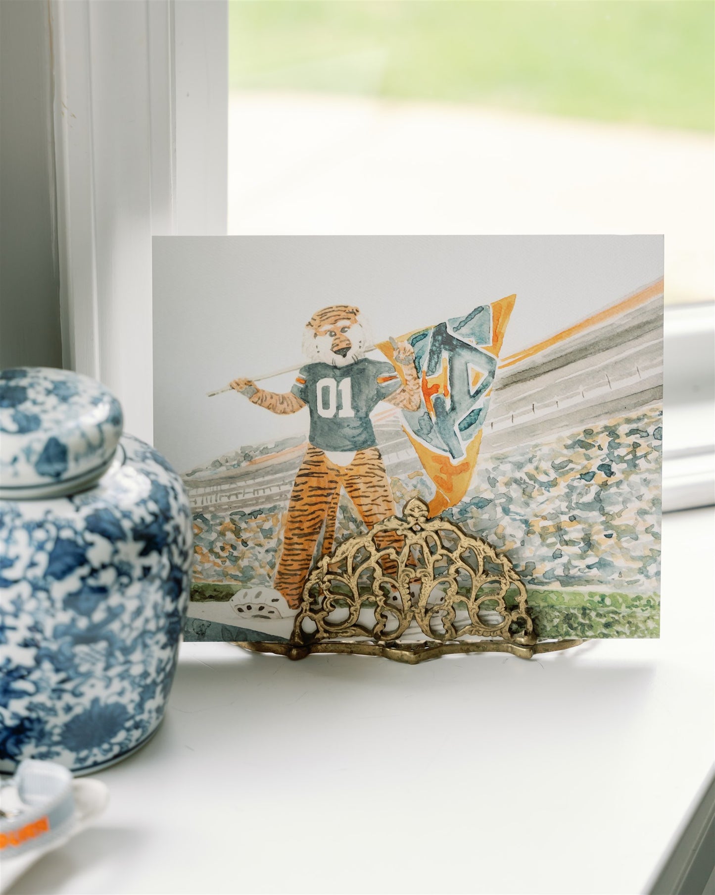 Watercolor art of Auburn University's mascot, Aubie, in Jordan Hare Stadium.