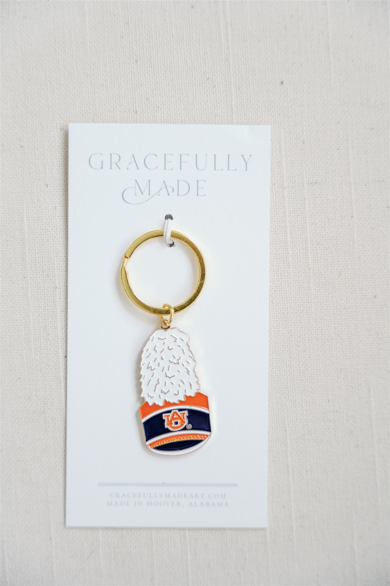 Enamel Keychain of the Auburn University Marching Band Hat with a gold chain.