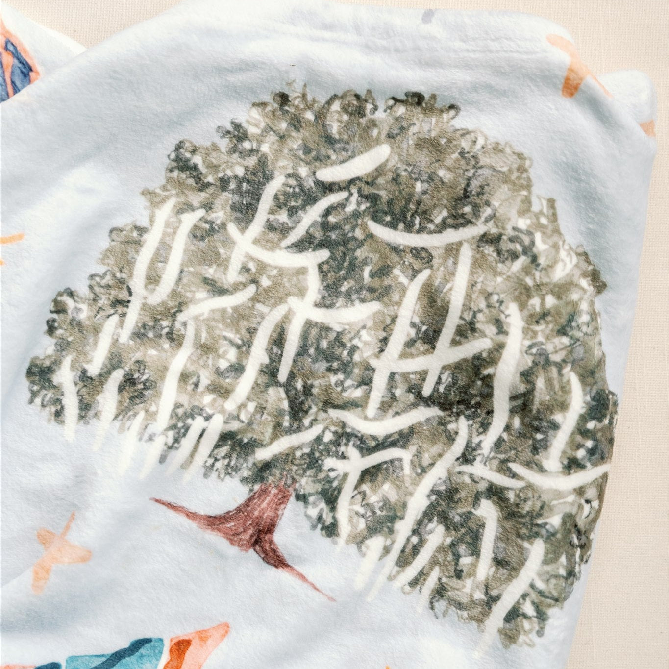 Light blue fleece blanket with watercolor Auburn University symbols.