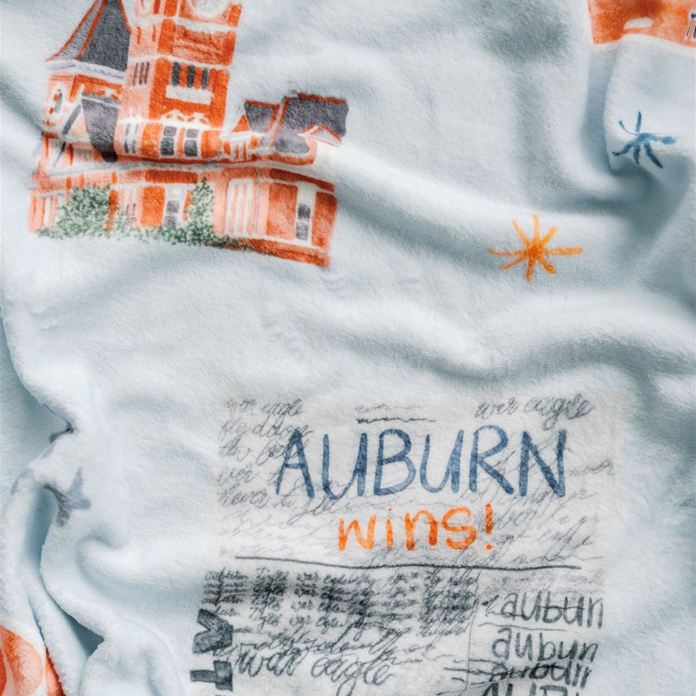 Light blue fleece blanket with watercolor Auburn University symbols.