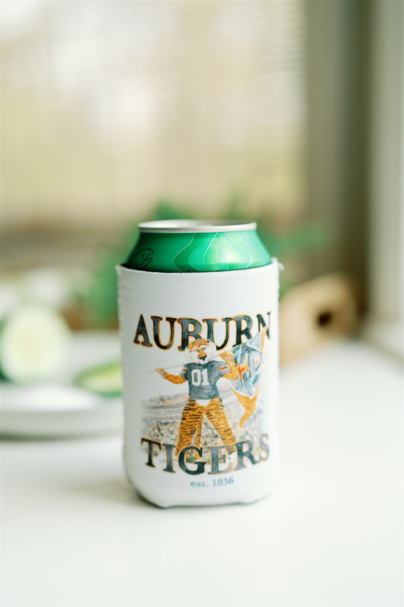 White Koozie with the Auburn University logo on one side and Aubie on the other.