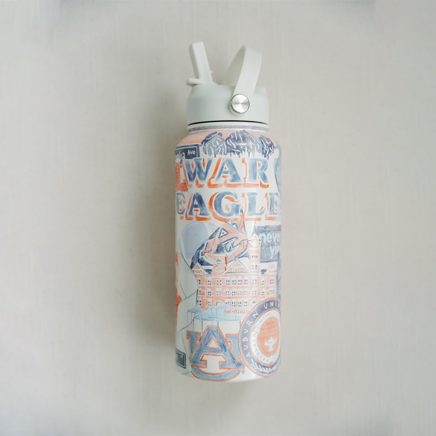 32 ounce water bottle featuring a collage of watercolor illustrations of Auburn University landmarks & icons.