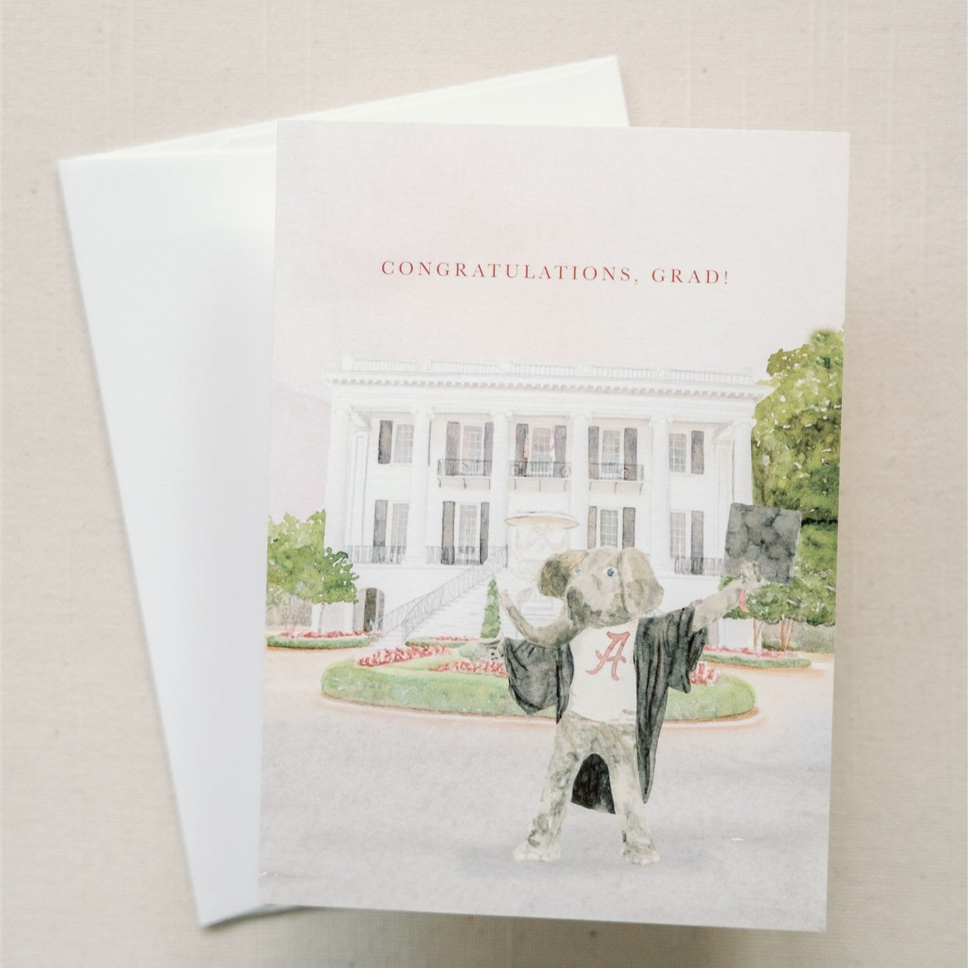Watercolor card of the University of Alabama mascot, Big Al, in a graduation cap and gown.