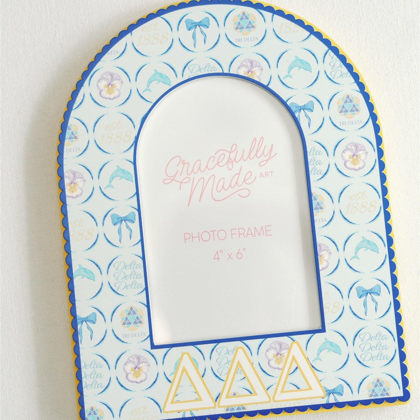 Decorative photo frame with Tri Delta pattern and Greek letters on a white background