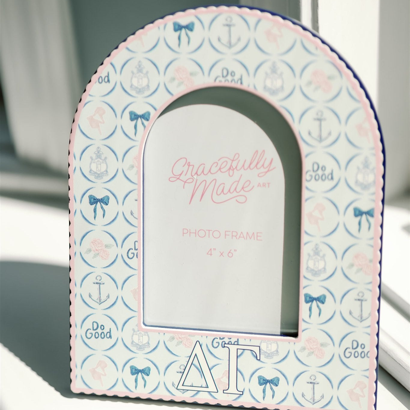 Decorative photo frame with Delta Gamma patterned border and 'Gracefully Made Art' branding.