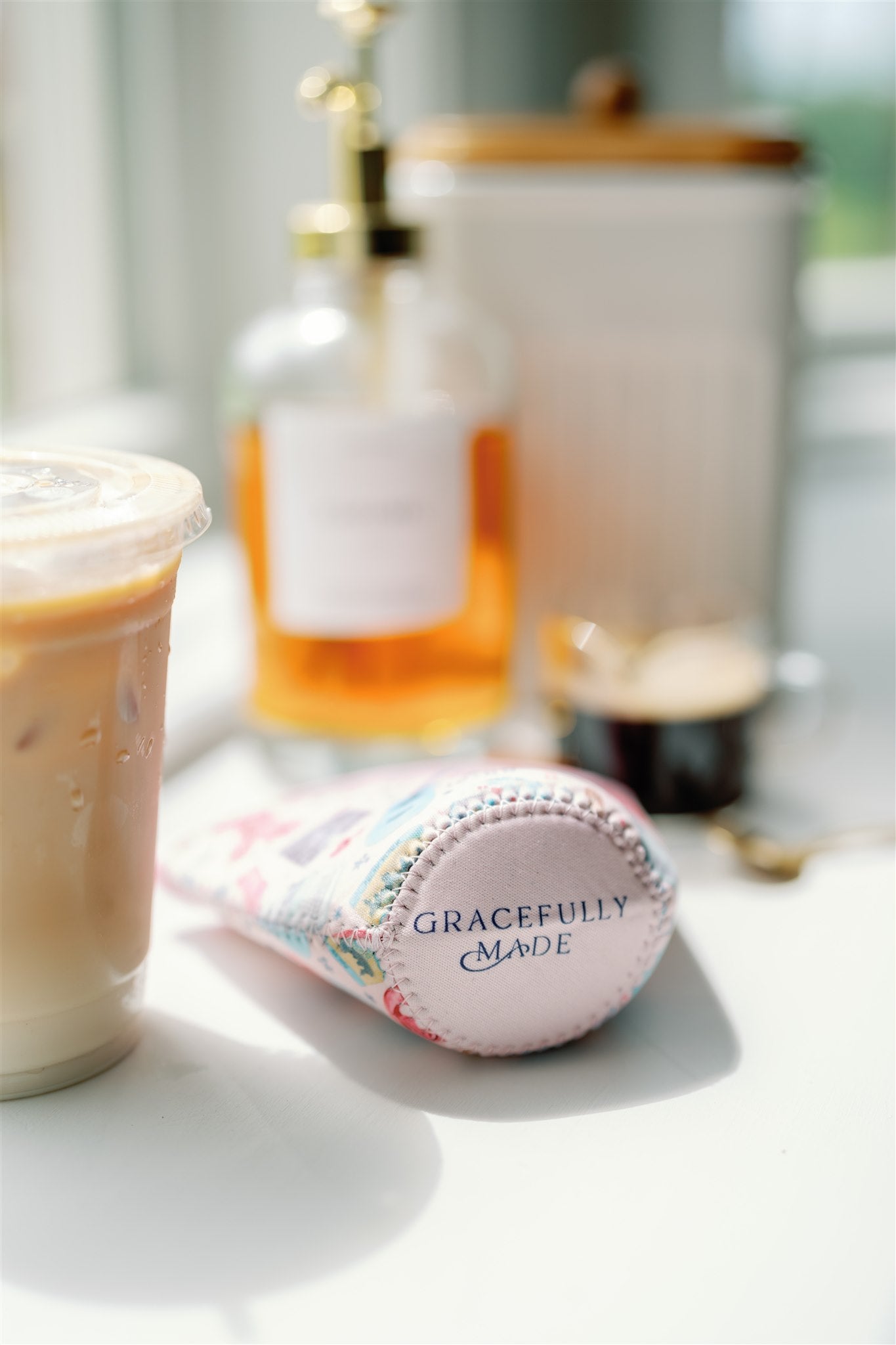 Light pink coffee sleeve with watercolor Taylor Swift inspired symbols.