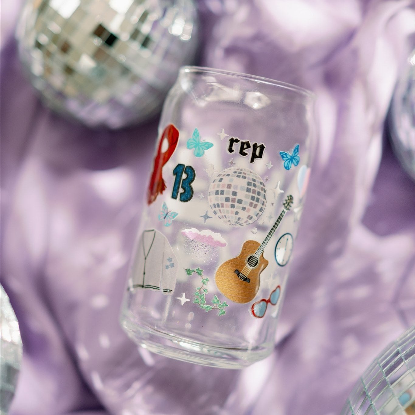Clear glass with Taylor Swift symbols on it.