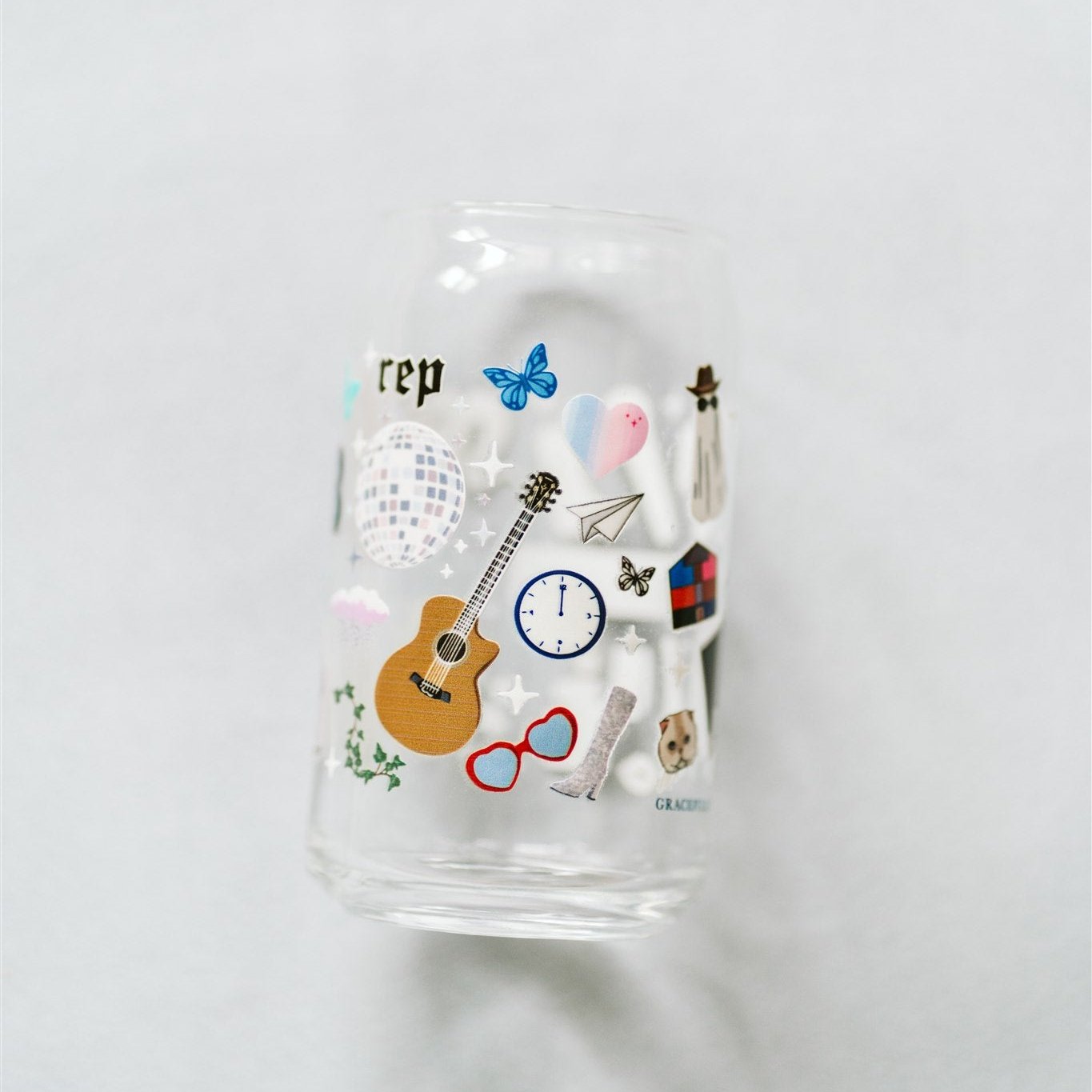 Clear glass with Taylor Swift symbols on it.