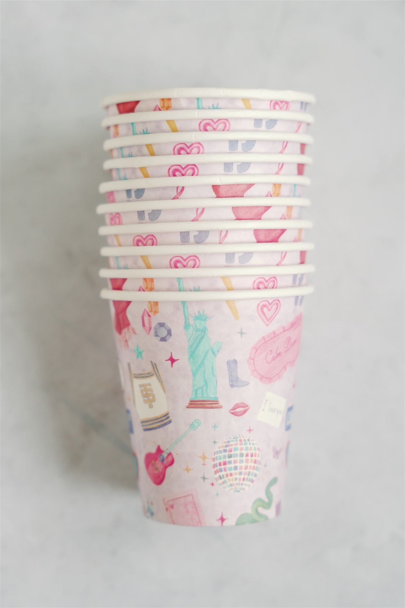 Light purple paper up patterned with original watercolor art of Taylor Swift symbols.