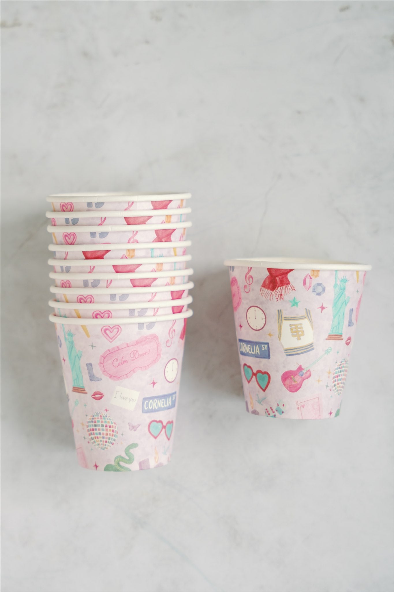 Light purple paper up patterned with original watercolor art of Taylor Swift symbols.