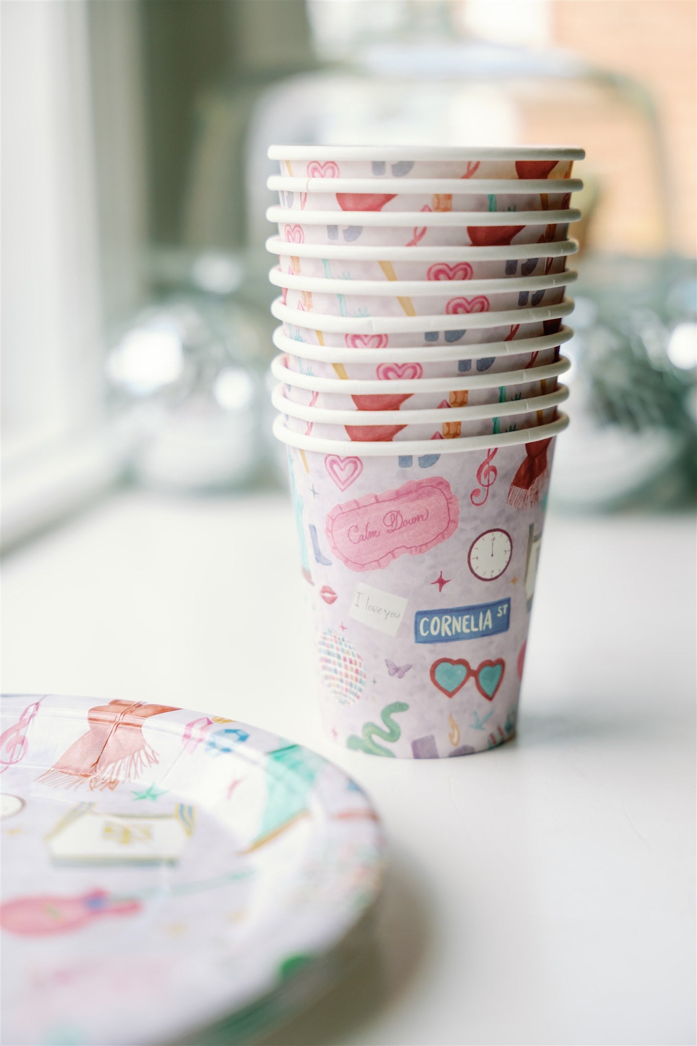 Light purple paper up patterned with original watercolor art of Taylor Swift symbols.