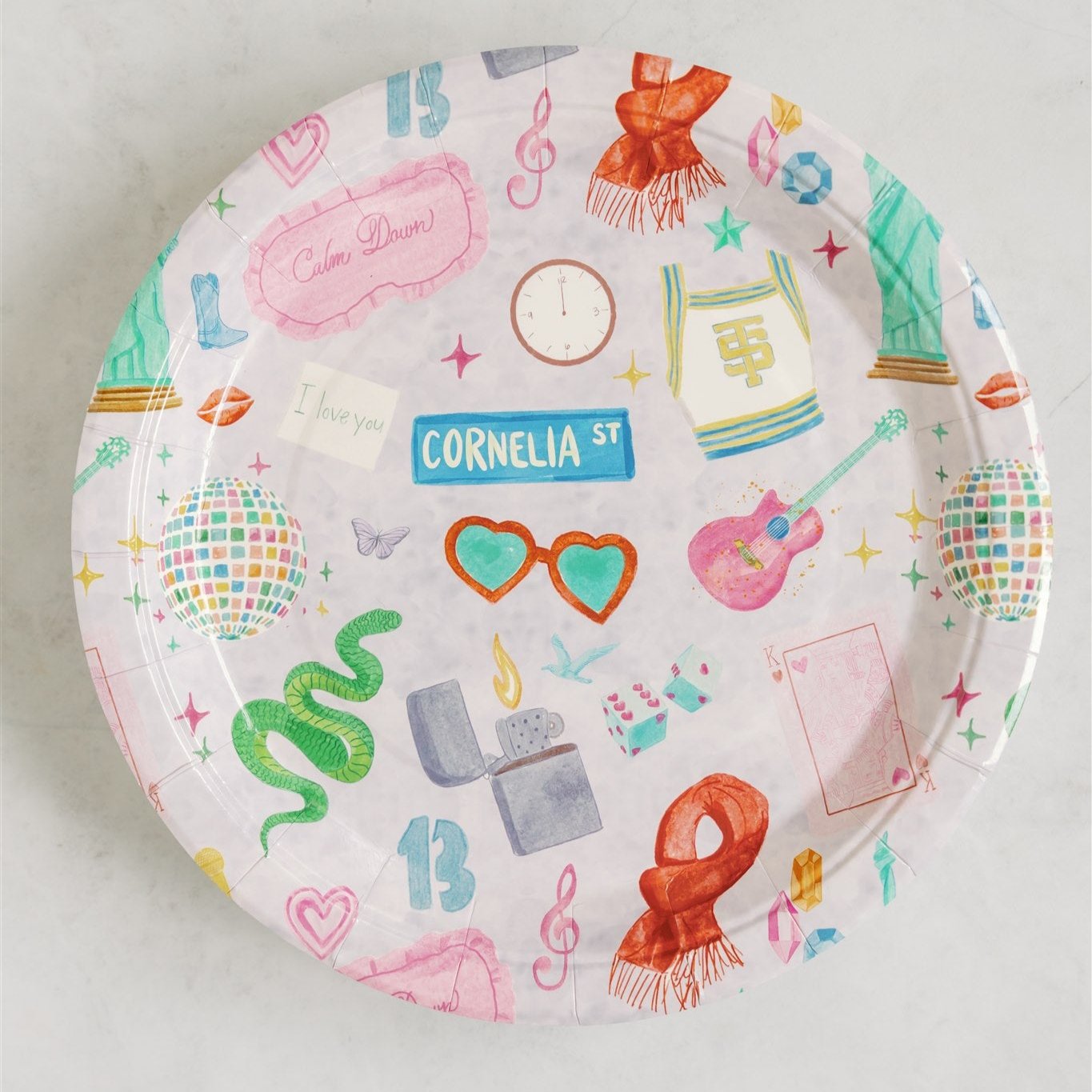 Light purple paper plate with original watercolor art of Taylor Swift icons.