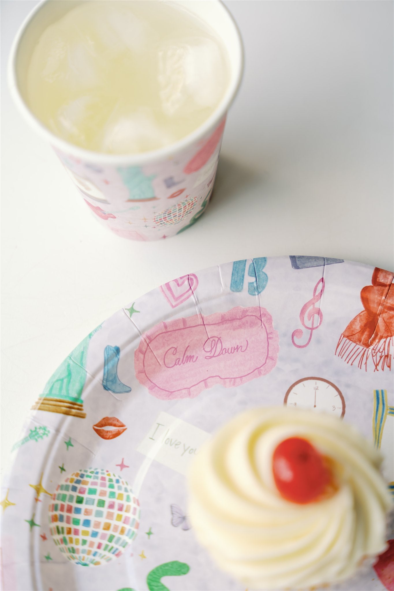 Light purple paper plate with original watercolor art of Taylor Swift icons.