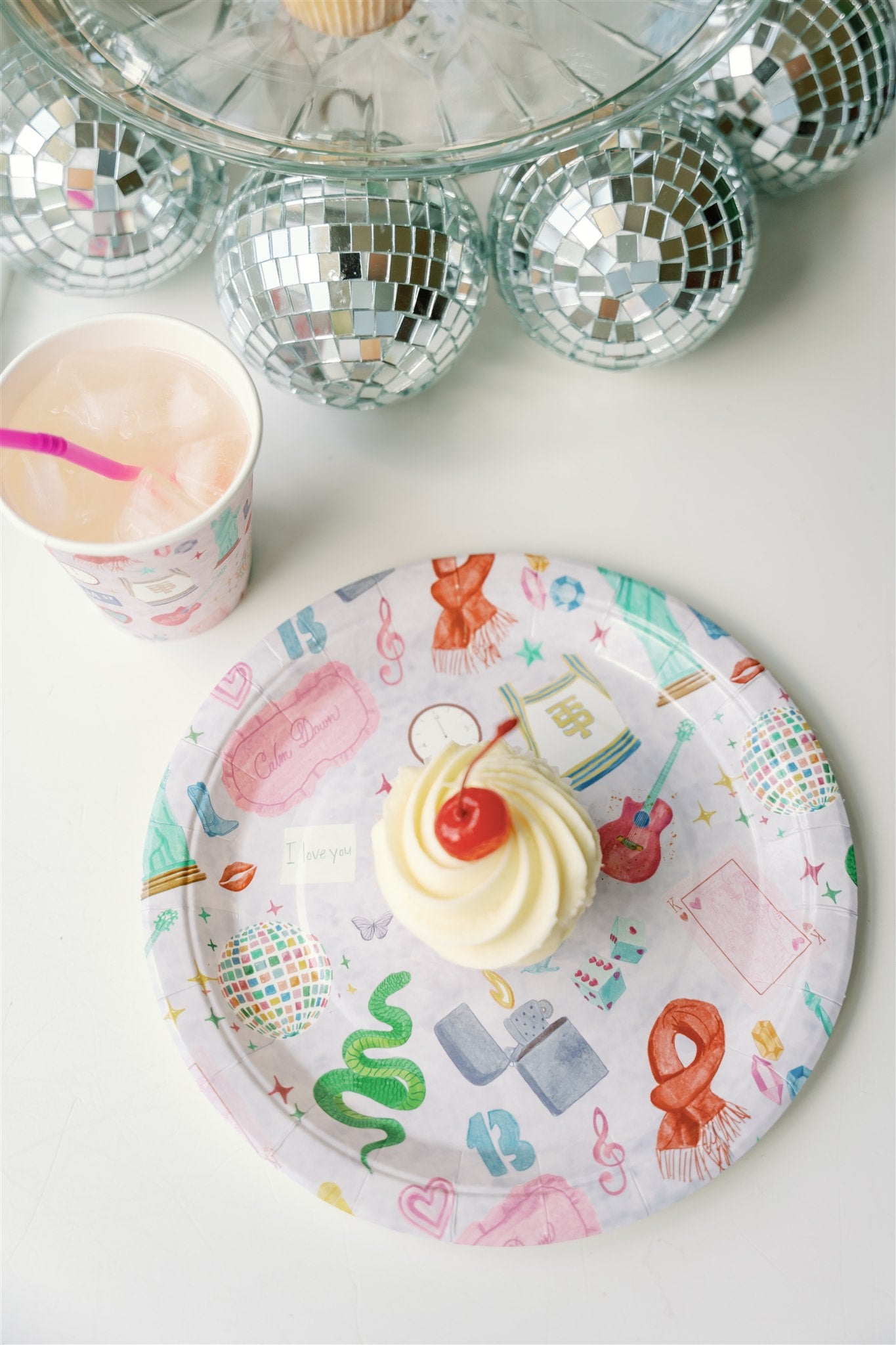 Light purple paper plate with original watercolor art of Taylor Swift icons.