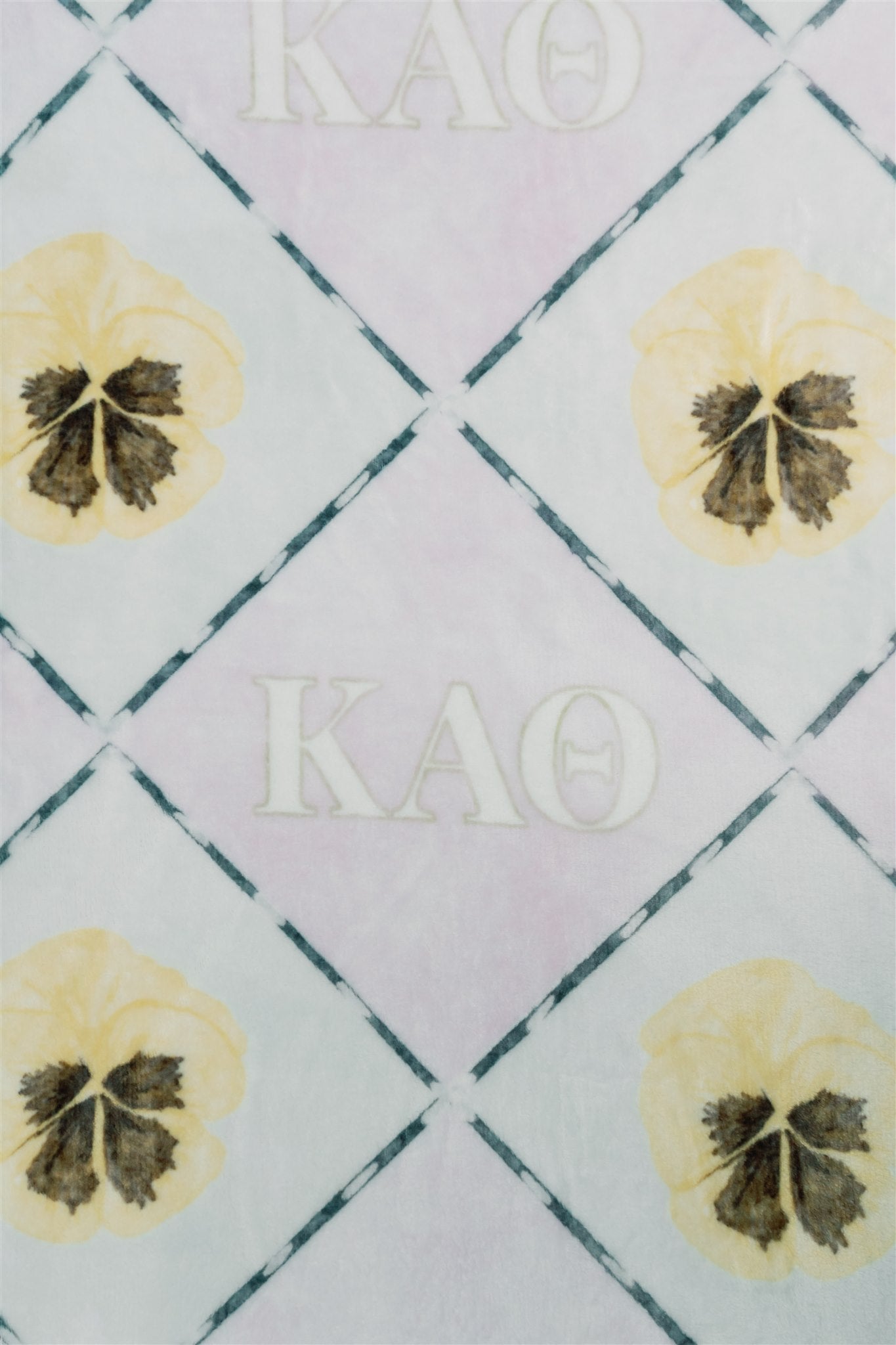 Patterned fabric with Kappa Alpha Theta text and flower designs on a checkered background