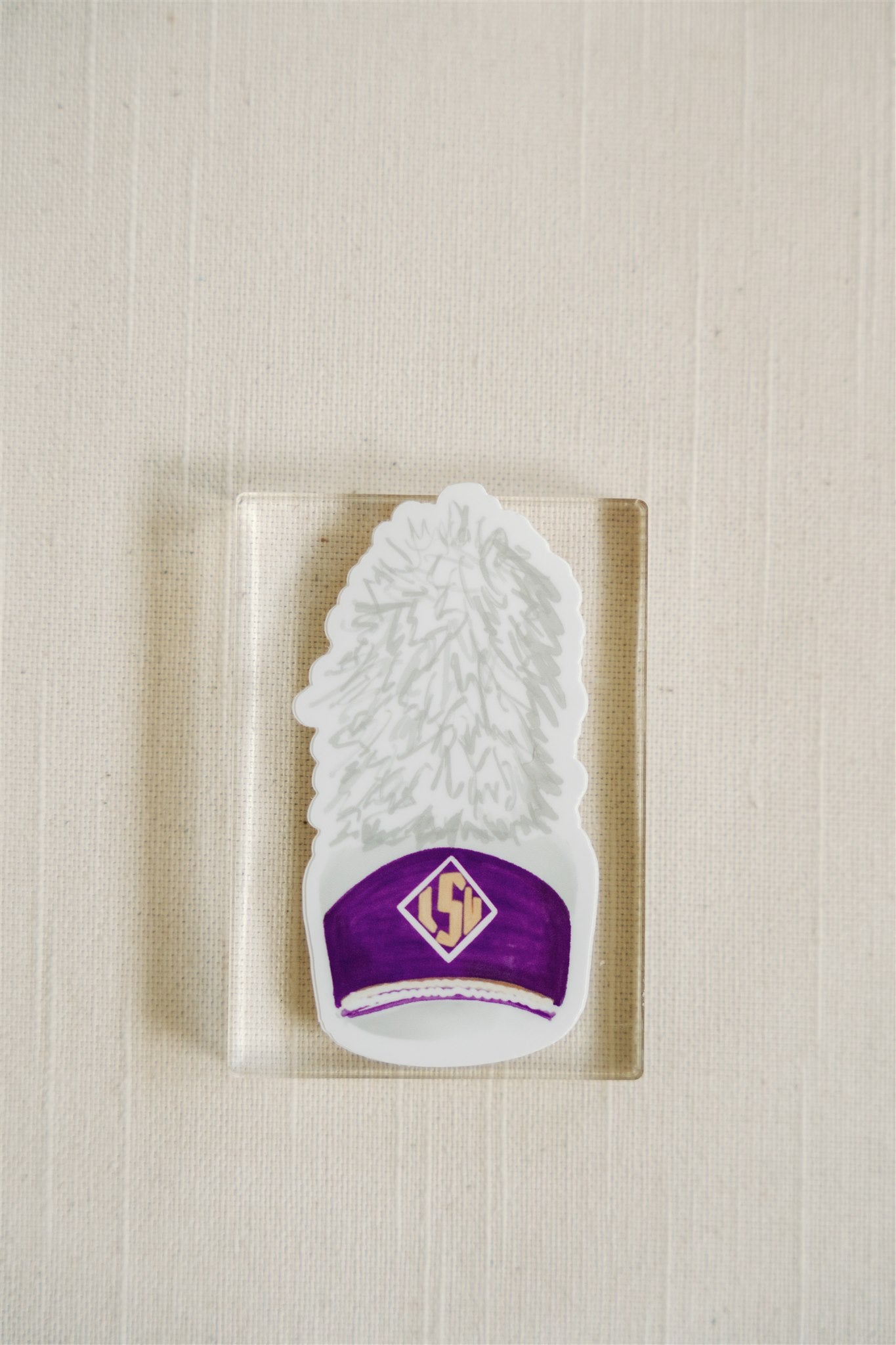 Sticker of watercolor art of an LSU band hat.