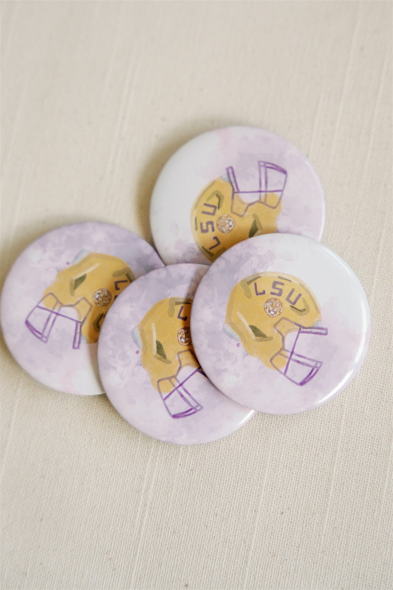 Purple game day button with an LSU Tigers football helmet on it.