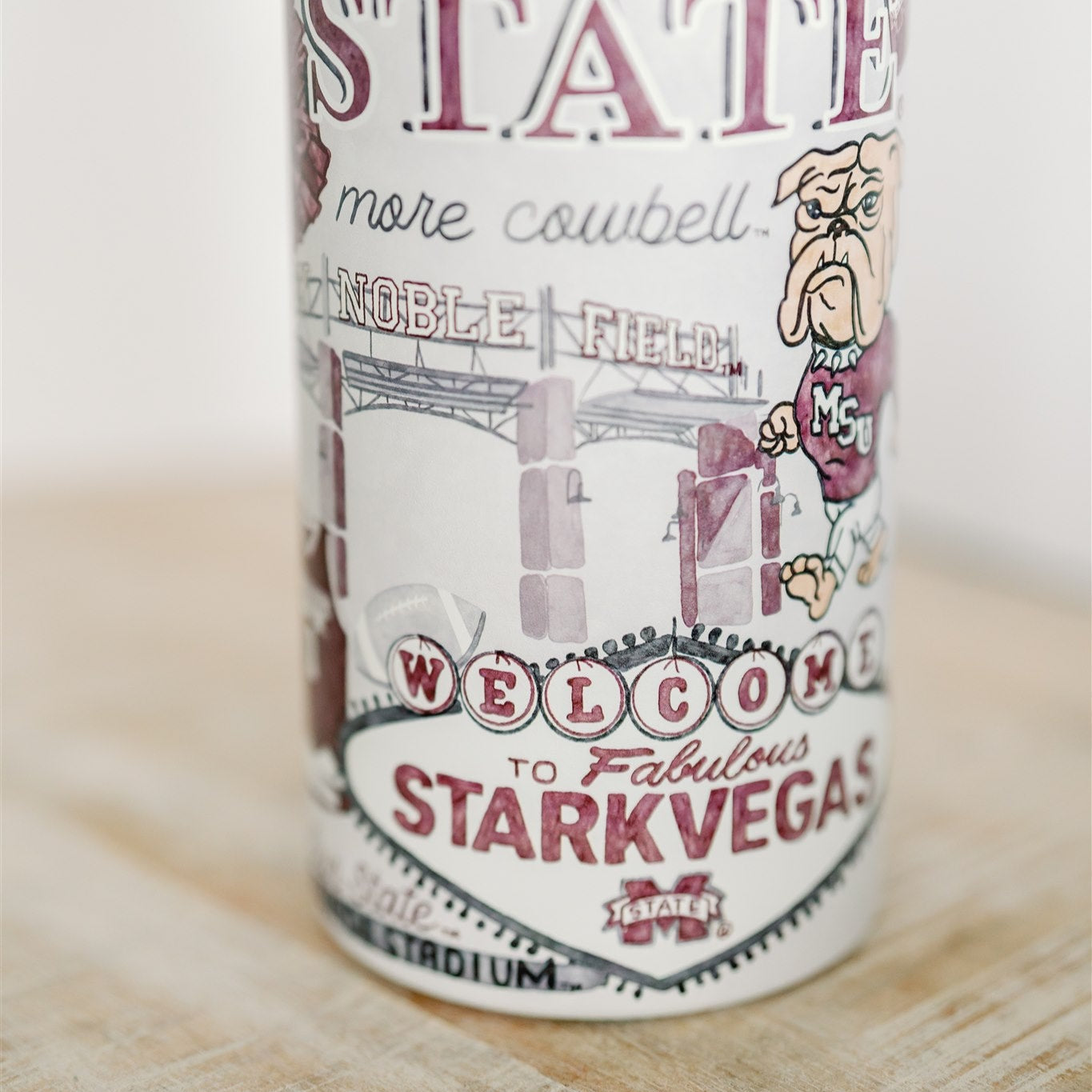 32 ounce water bottle with a white lid and is patterned with watercolor art of Mississippi State symbols.
