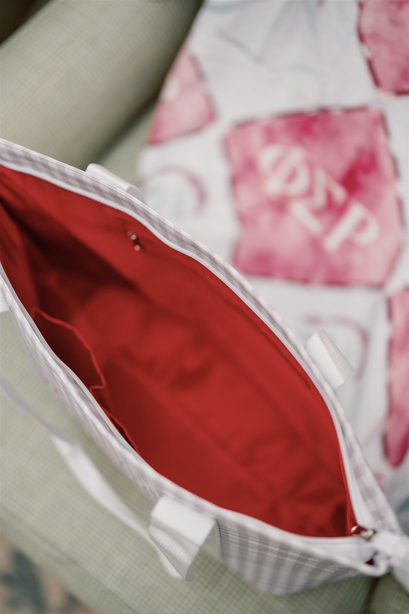 Close-up of the Phi Sigma Rho tote bag's red interior liner and pockets