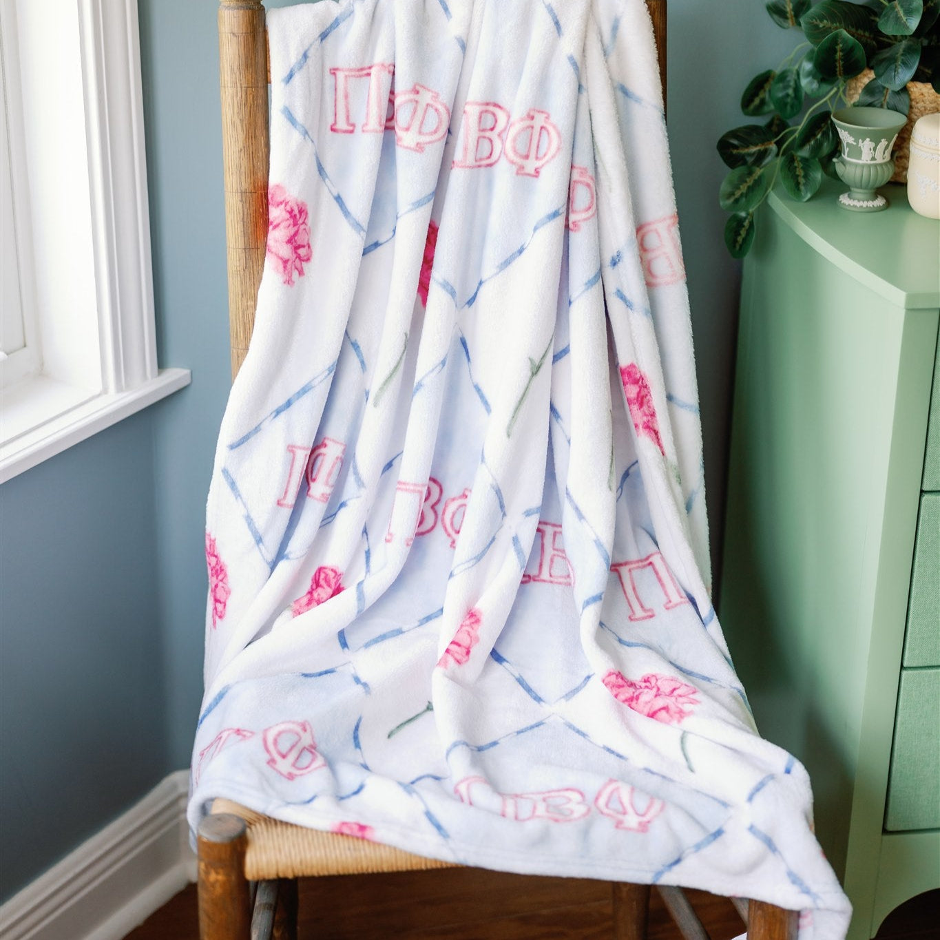 Blanket with Pi Beta Phi Greek letters draped over a chair.