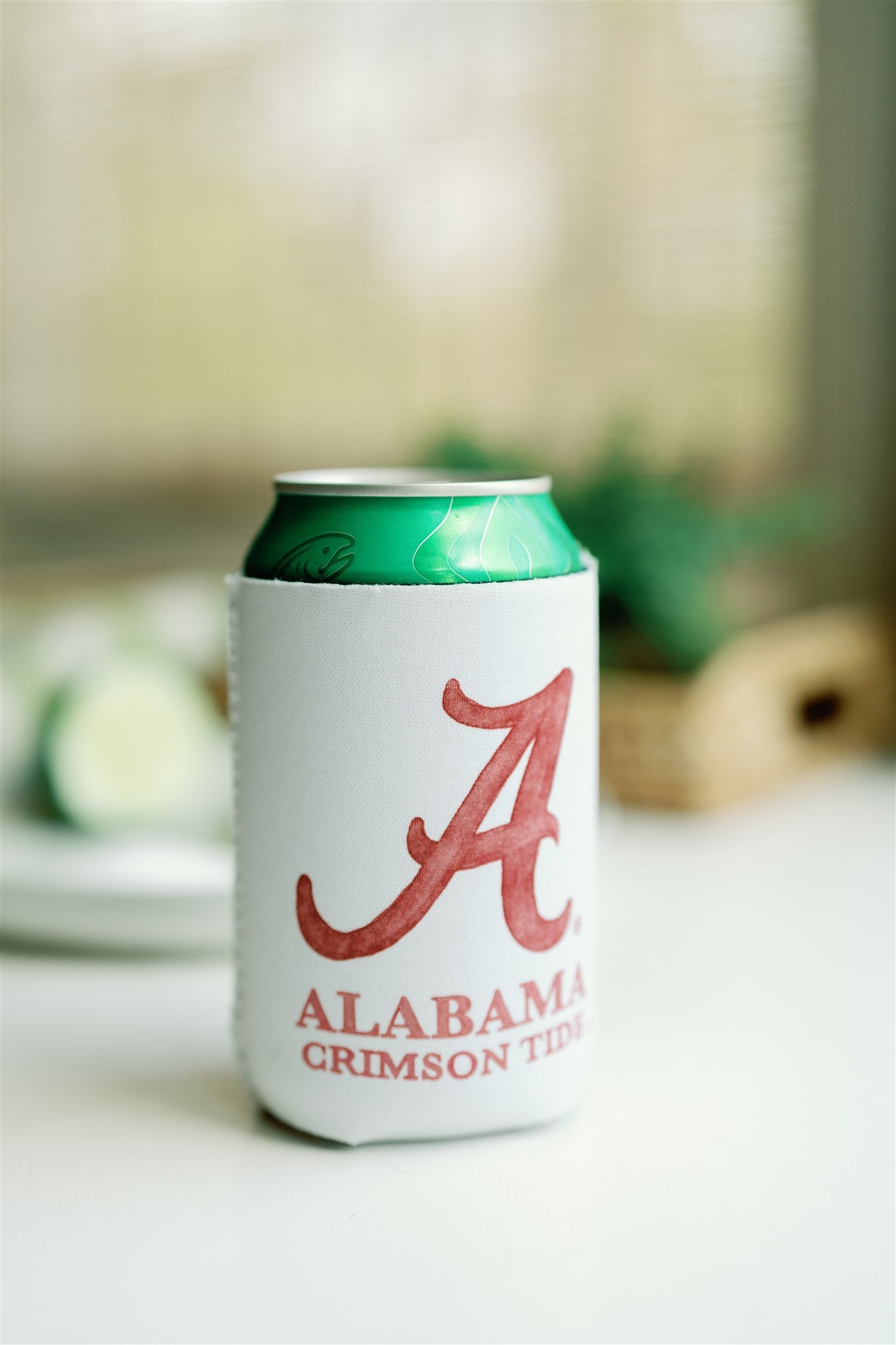 White Koozie with watercolor University of Alabama logo on one side and Big Al on the other side.