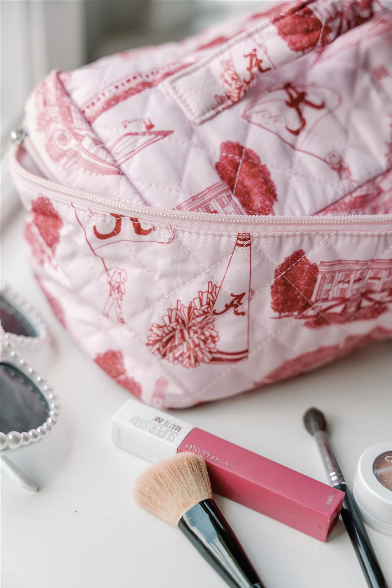 White Make Up Bag with red University of Alabama symbols and a handle on the top.