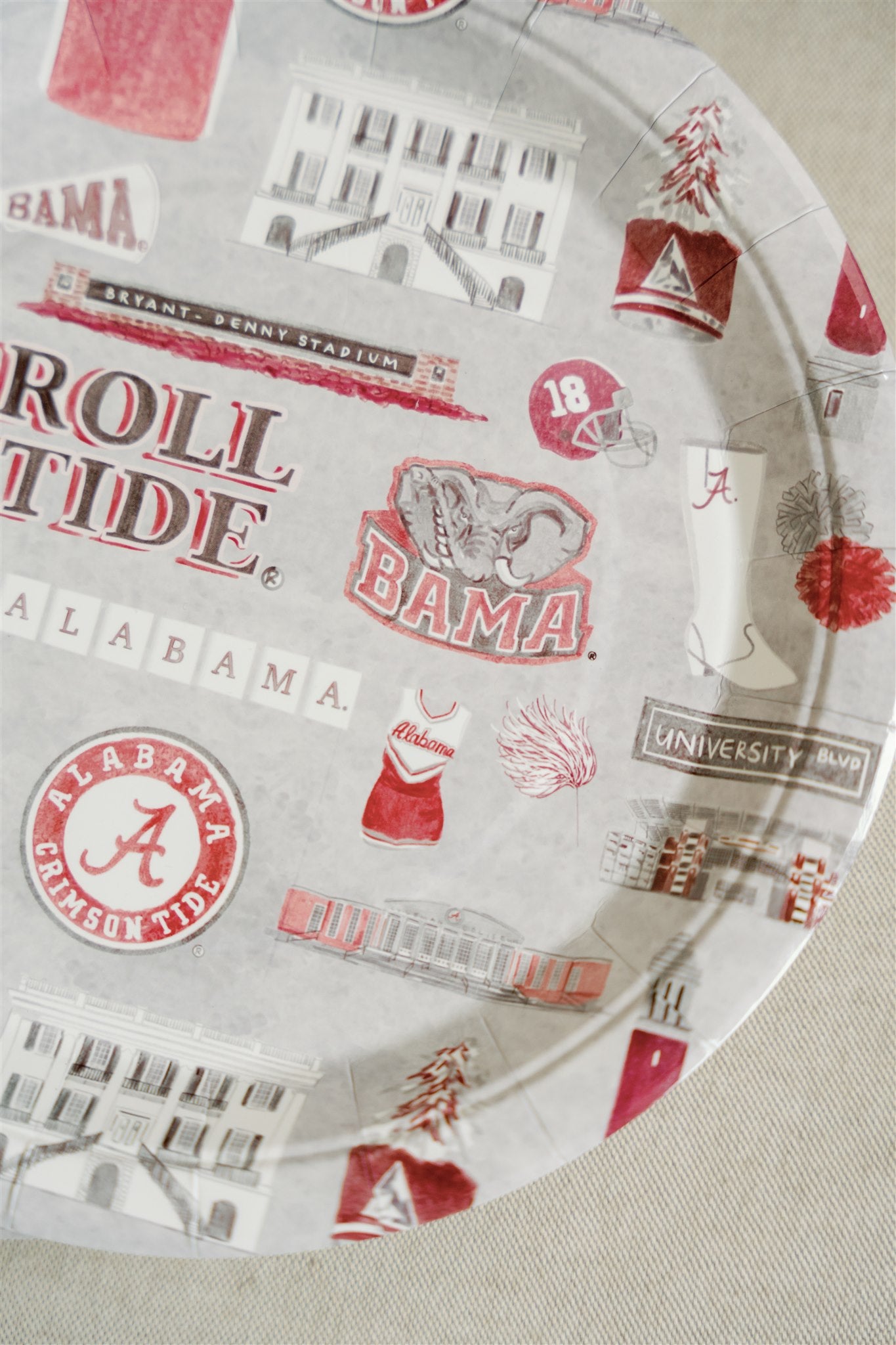 Light grey paper plate with watercolor University of Alabama symbols.