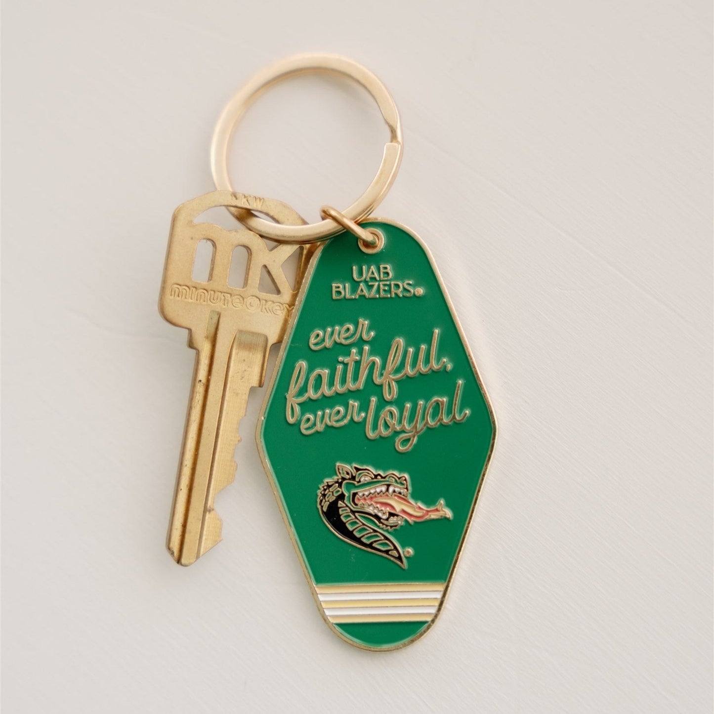 Green enamel keychain with "ever faithful ever loyal" and the UAB mascot on it in gold.