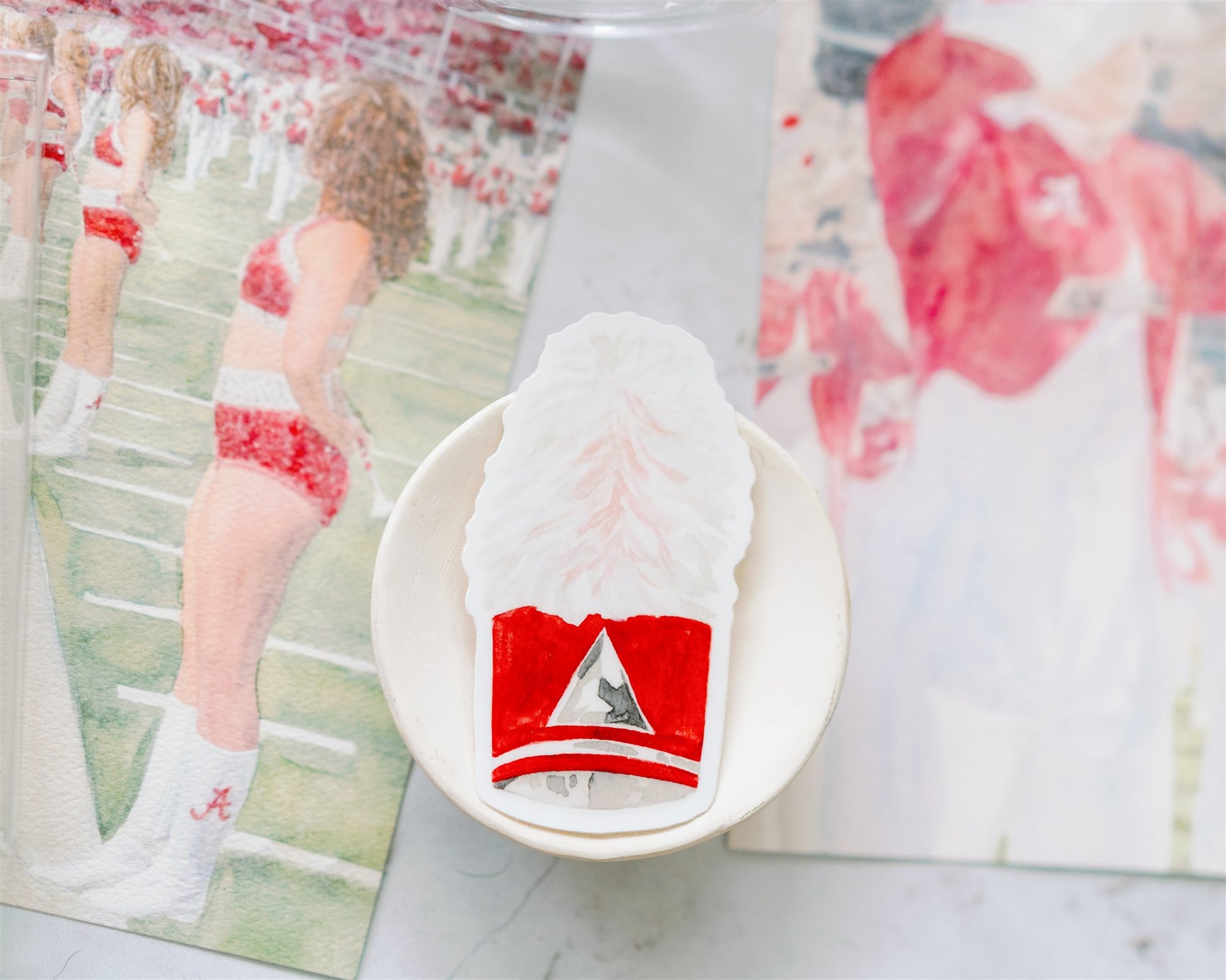 Sticker of a watercolor University of Alabama marching band hat.