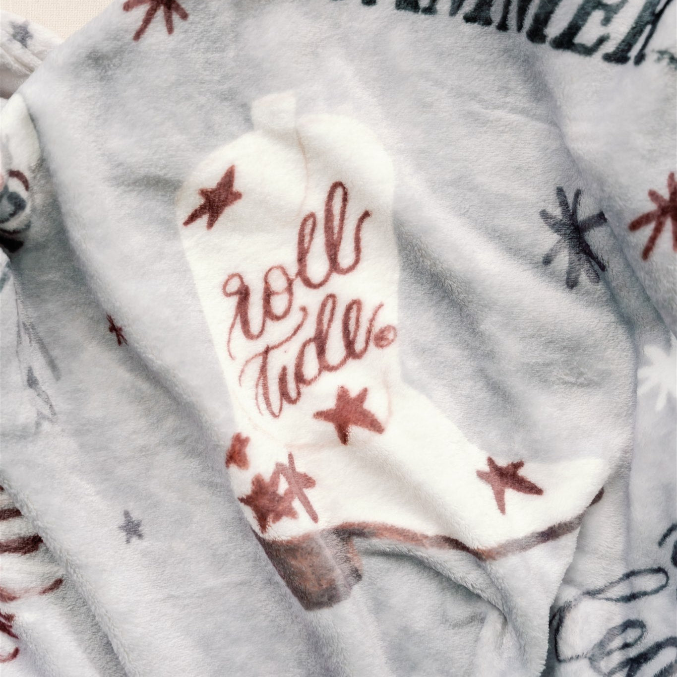Light grey flannel fleece blanket themed to University of Alabama.