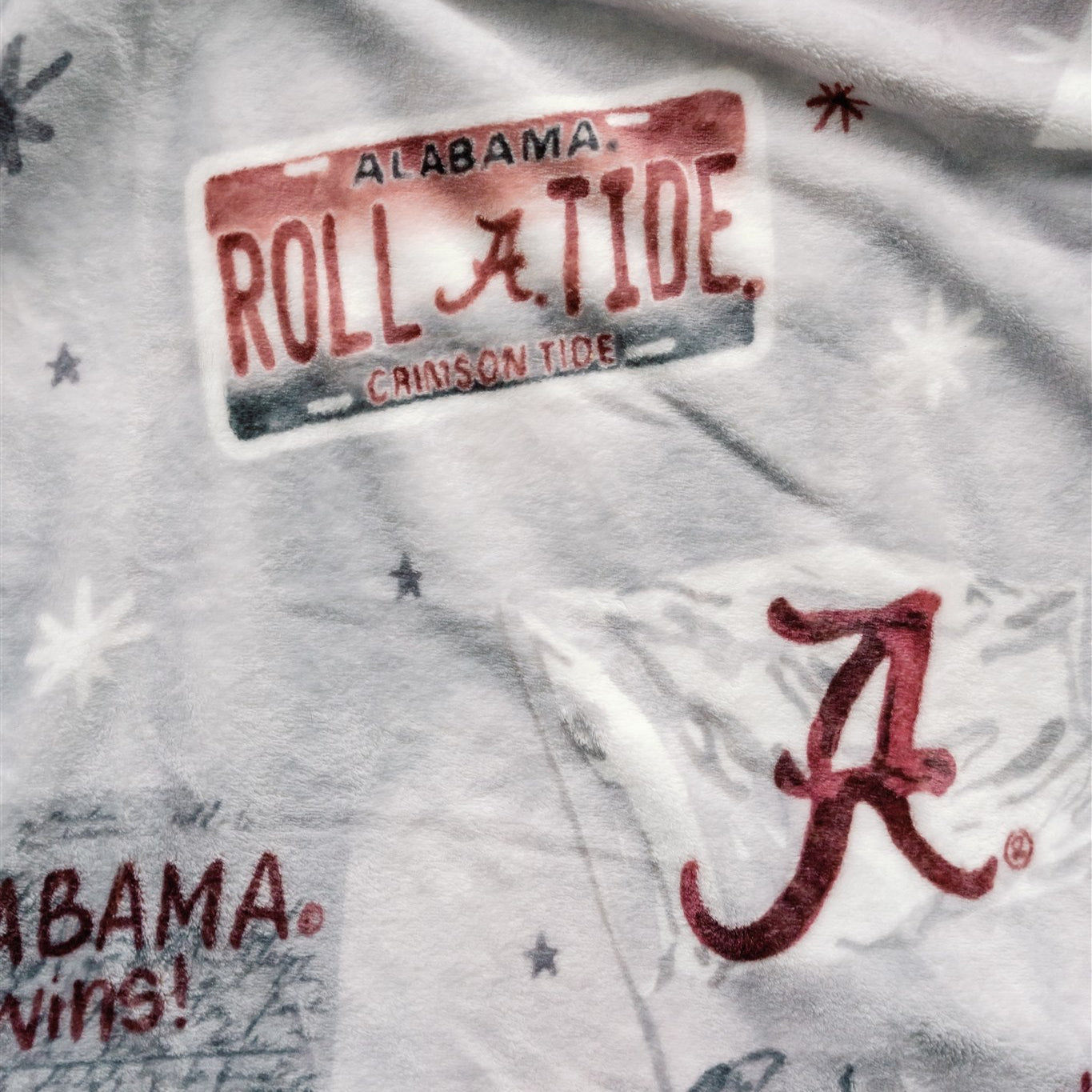 Light grey flannel fleece blanket themed to University of Alabama.