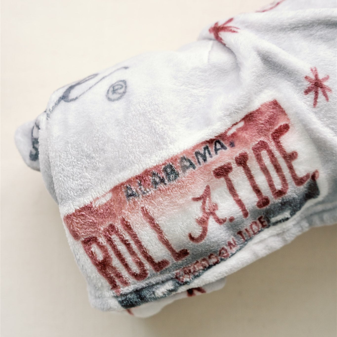 Light grey flannel fleece blanket themed to University of Alabama.