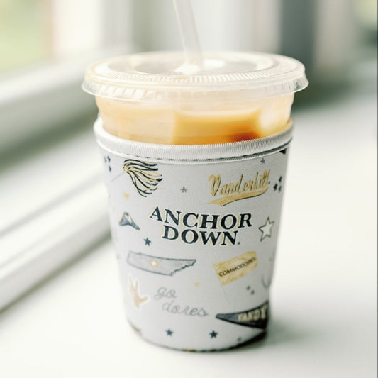 Light grey coffee sleeve with Vanderbilt University logos and symbols.