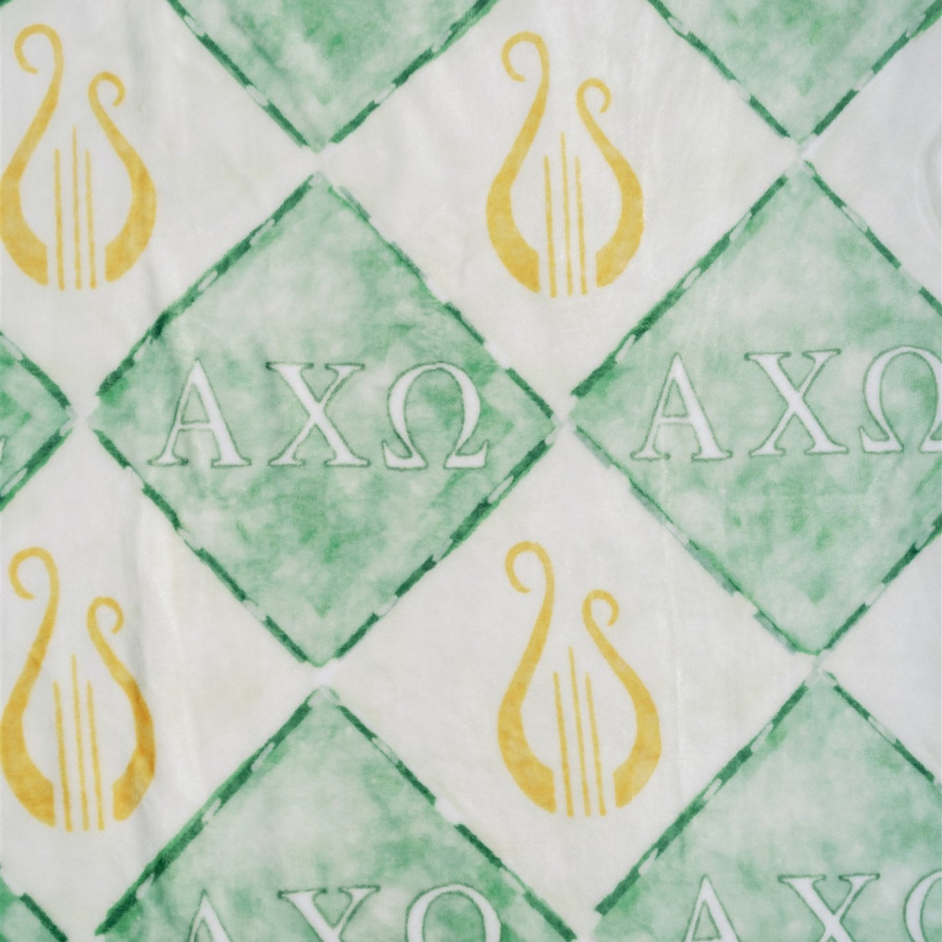 Blanket pattern with 'AXO' symbols on a checkered green and white background