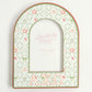 Decorative arch-shaped frame with 'Alpha Chi Omega' initials on a white background