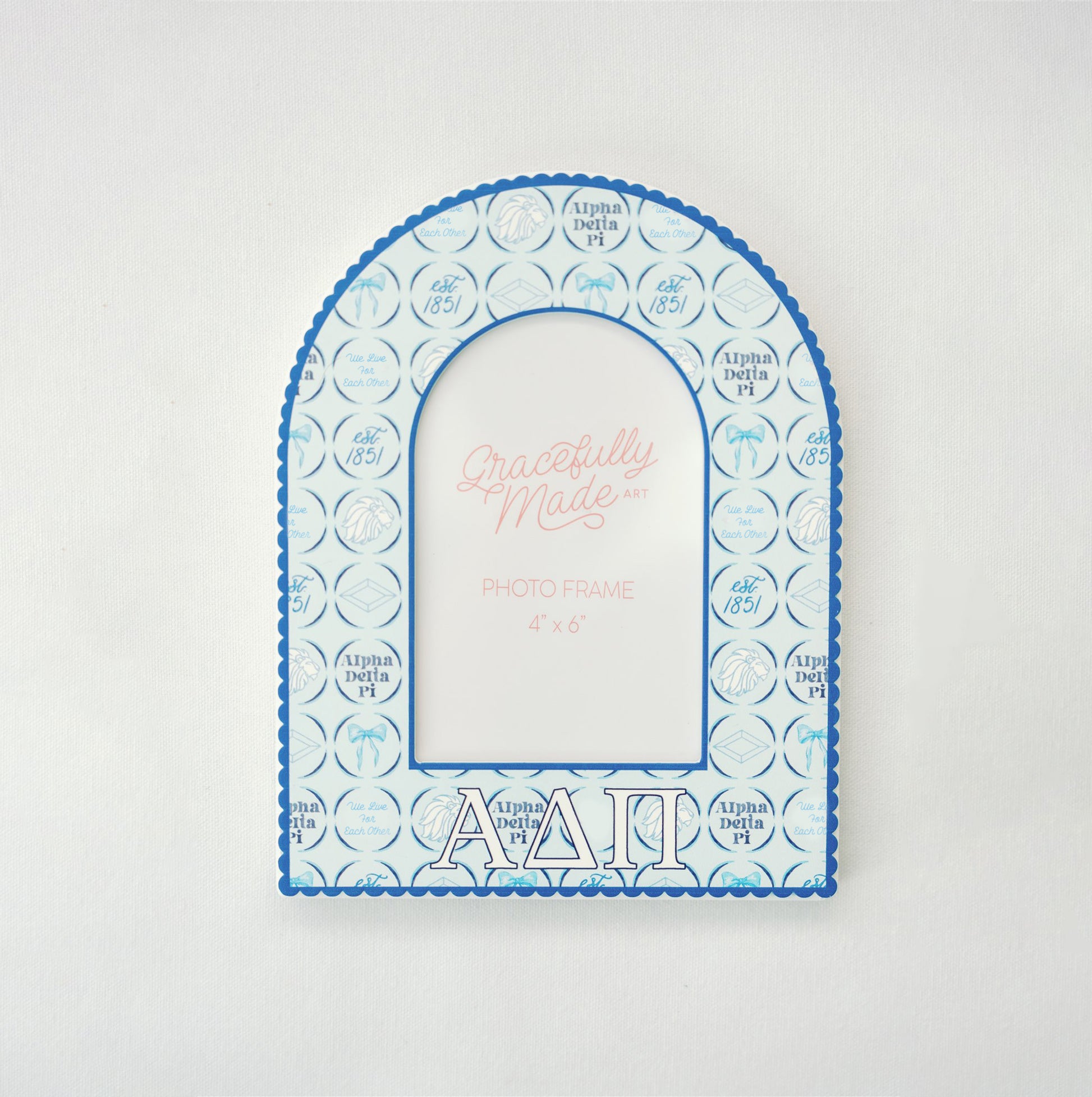 Decorative photo frame with Alpha Delta Pi blue and white design on a light gray background