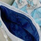 Close-up of the Alpha Delta Pi tote bag with a blue interior.