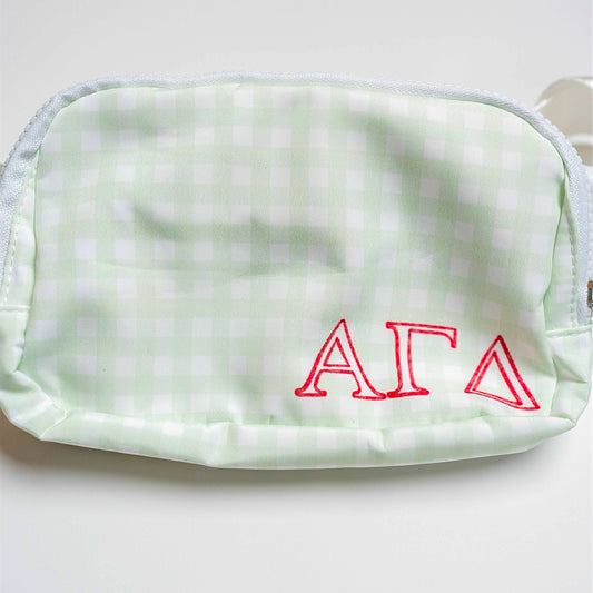 Light green gingham pouch with red Alpha Gamma Delta letters on a white background