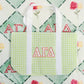 Tote bag with Alpha Gamma Delta Greek letters on a patterned background