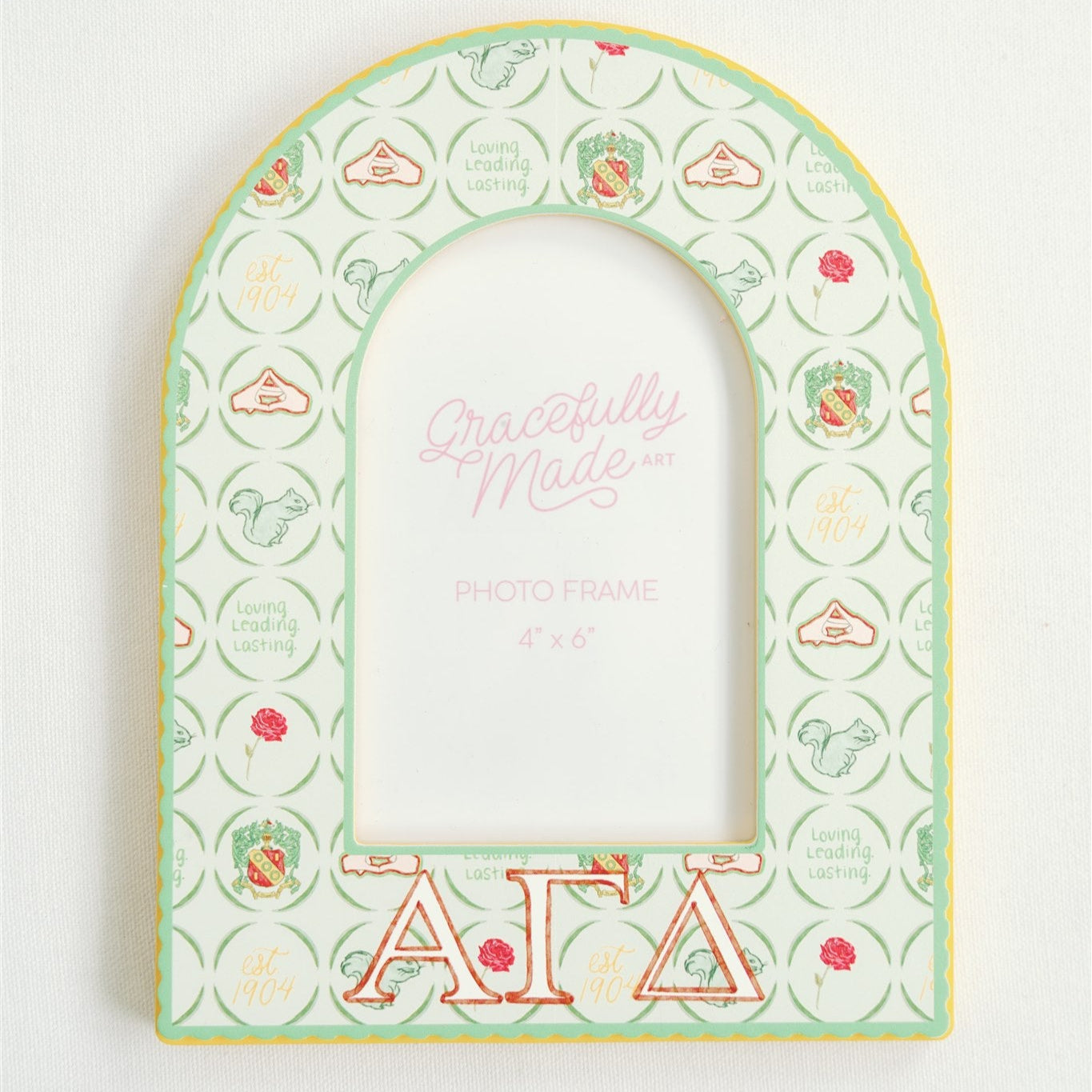 Decorative frame with Alpha Gamma Delta Greek letters and design on a white background