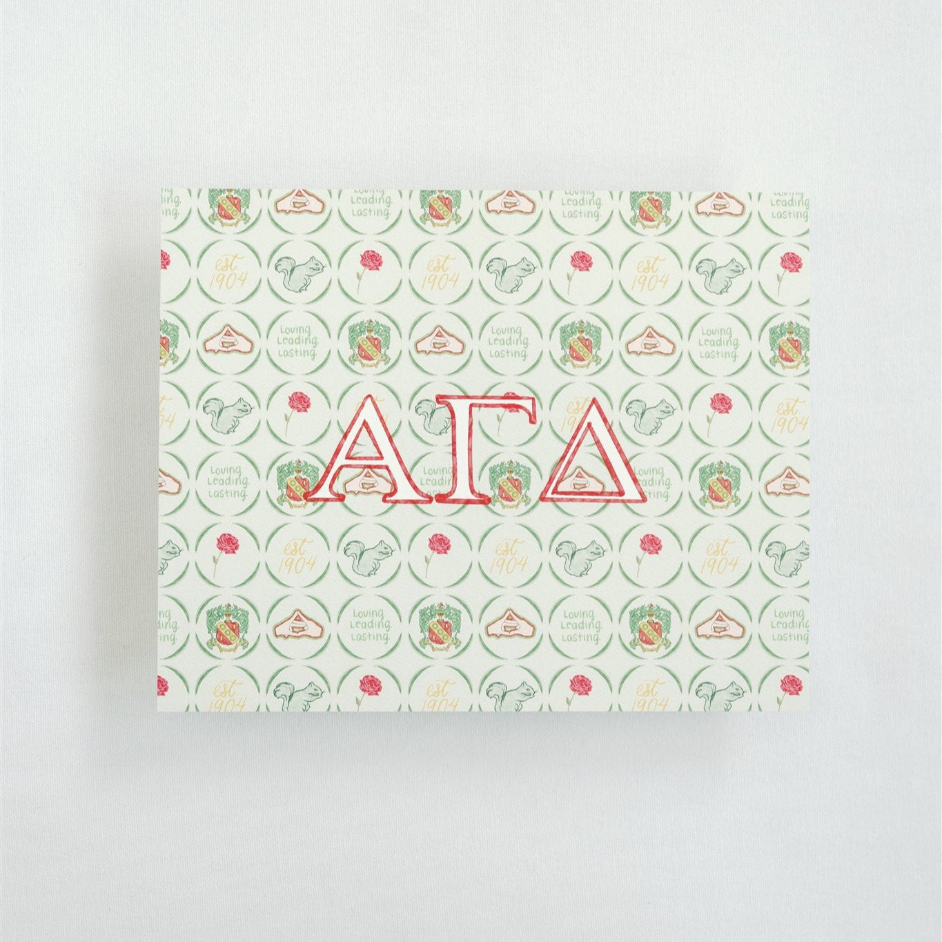 Art print with 'Alpha Gamma Delta' Greek letters on a patterned cover against a white background