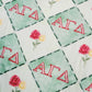 Pattern of 'ΑΓΔ' letters with red roses on a green background