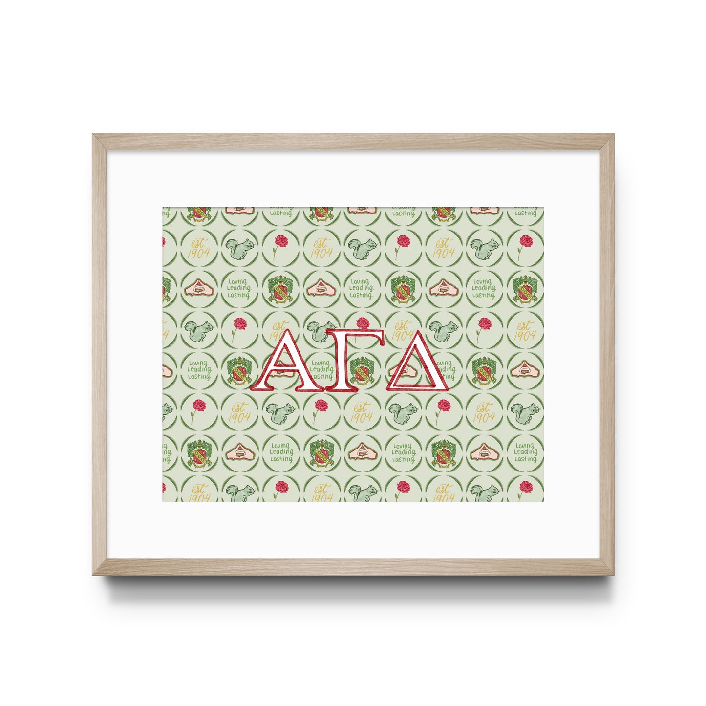 Framed artwork with Alpha Gamma Delta Greek letters and pattern on a white background