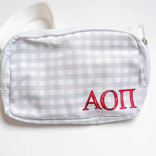 White checkered belt bag with red Alpha Chi Omega Greek letters on a white background