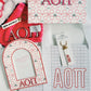 Collection of Alpha Omicron Pi merchandise including a keychain, photo frame, and art print on a white background.